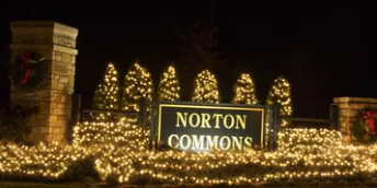neighborhood entrance decorated with Christmas lights