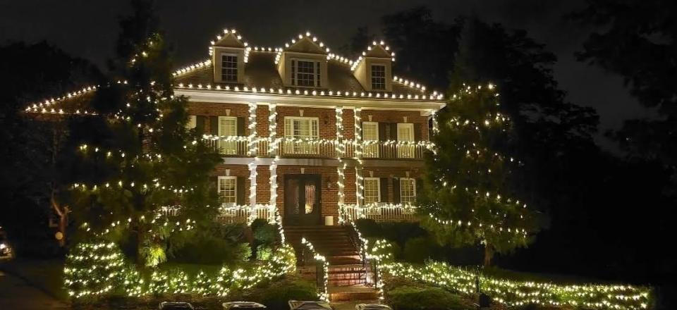 white Christmas lights on two story brick home